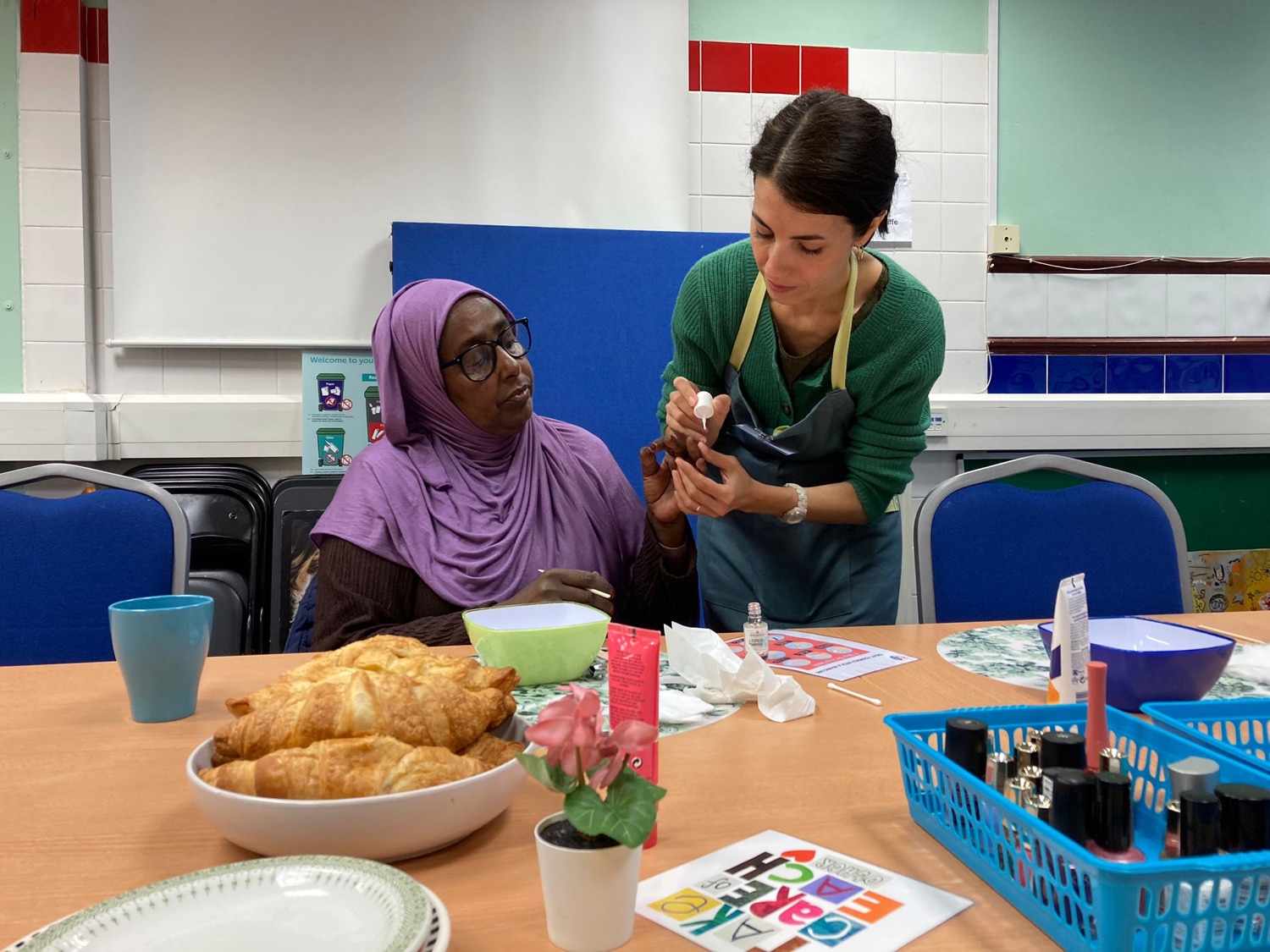 Natacha painting a participant's nails